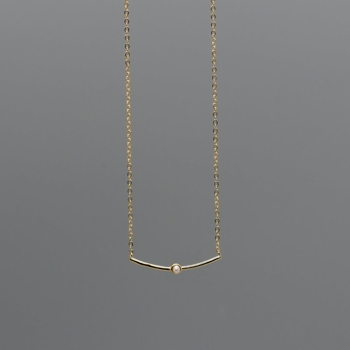 Curved bar with pearl necklace