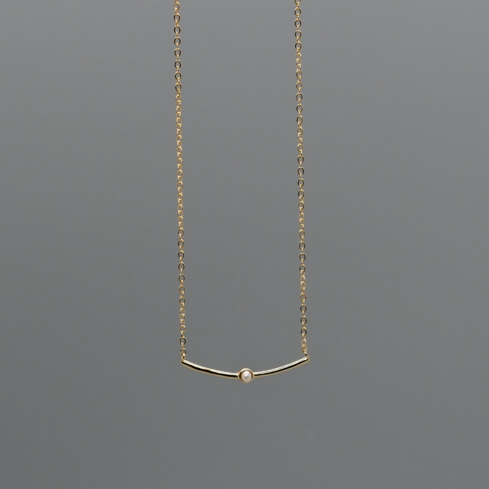 Curved bar with pearl necklace
