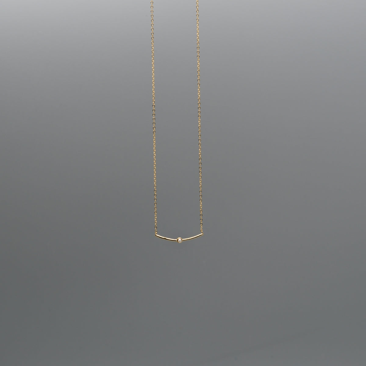 Curved bar with pearl necklace