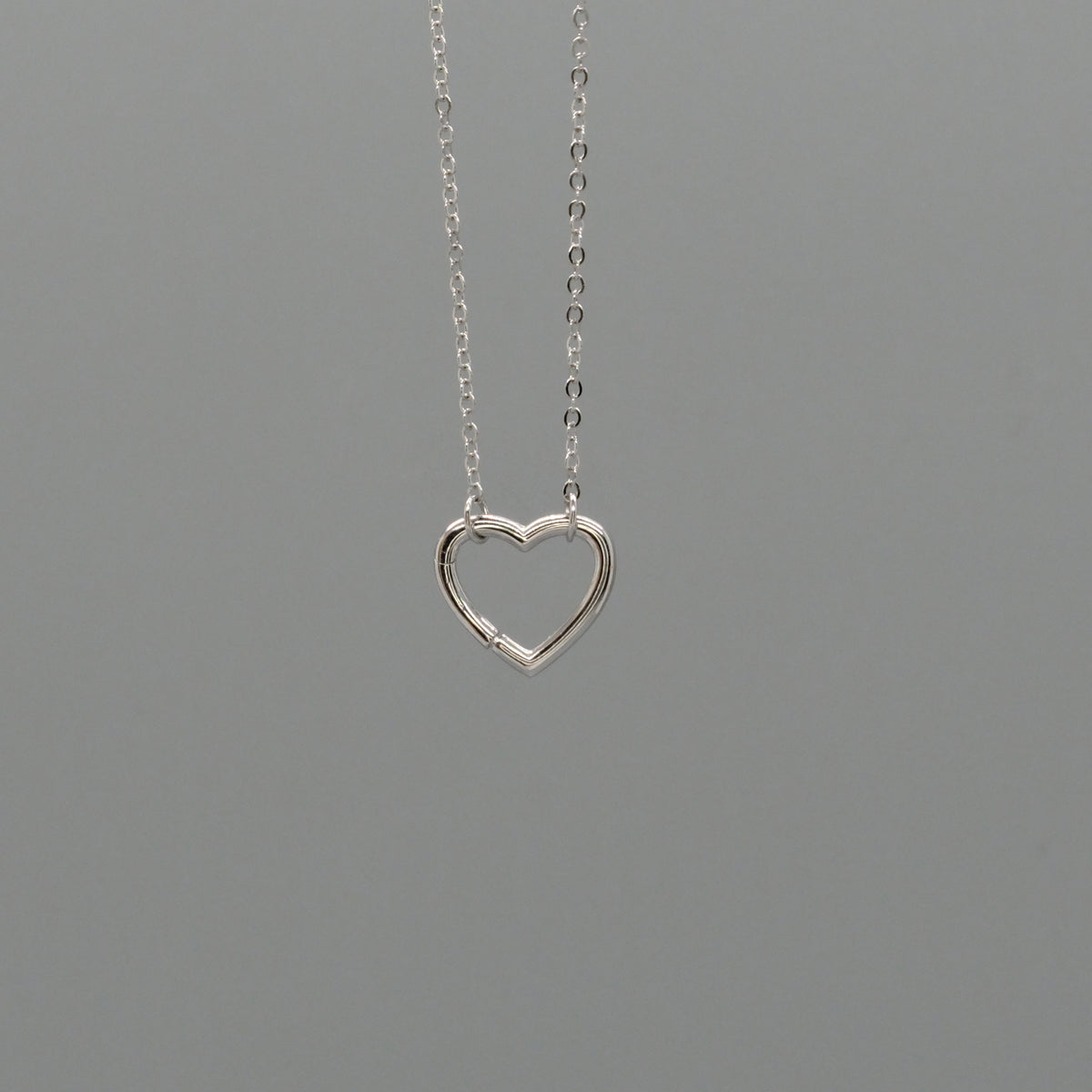Open heart charm necklace