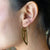 Brass wing disc hoop earrings