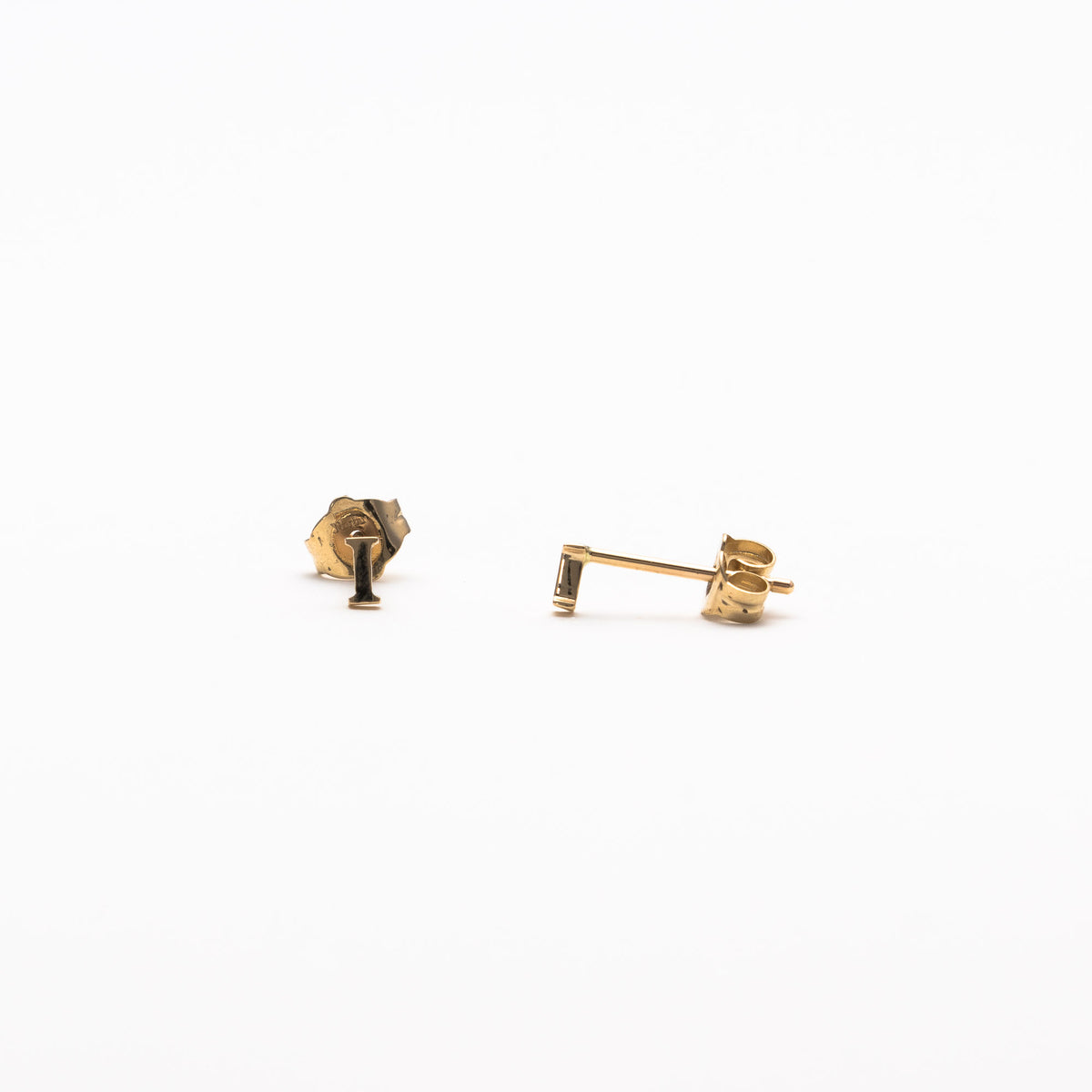 Single initial studs in yellow gold