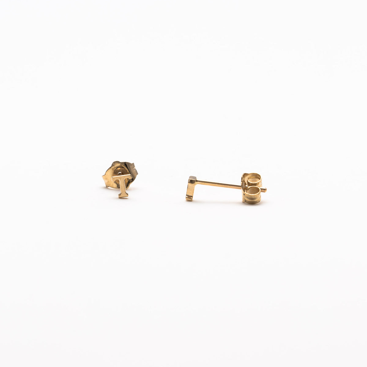 Single initial studs in yellow gold